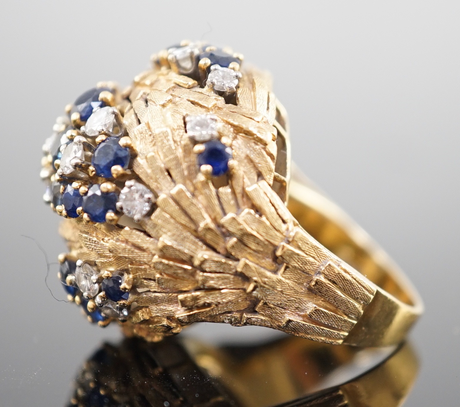 A mid 20th century textured 18ct gold, sapphire and diamond cluster set domed dress ring, by E. Meister, Zurich